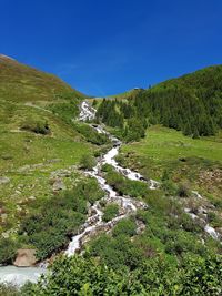 Scenic view of mountains against clear blue sky