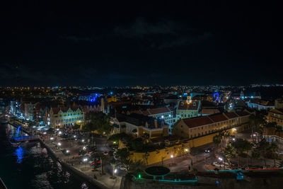 High angle view of illuminated buildings in city at night
