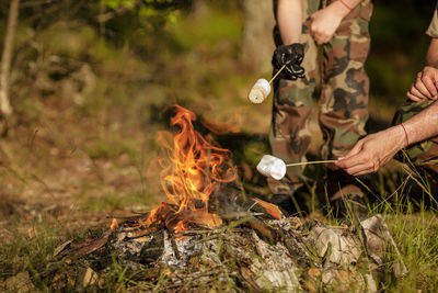 Midsection of man holding fire