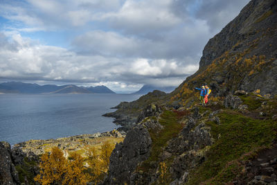 Couple looking at lake view from top of mountain