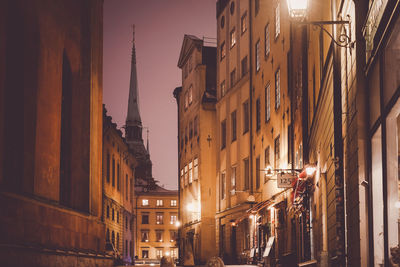 Street amidst buildings at night