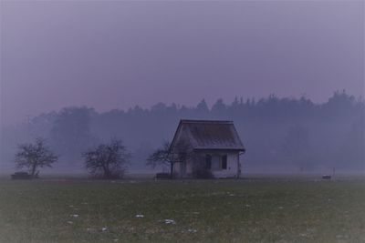 Hut on field against sky