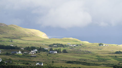 Scenic view of green landscape against sky