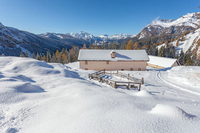 Alpine hut immersed in a delightful winter panorama, dolomites, italy
