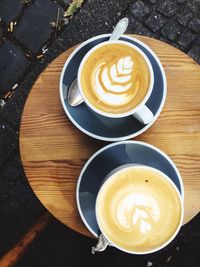 Directly above shot of coffee cups on table at sidewalk cafe