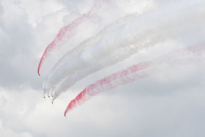 Low angle view of airplane flying against sky