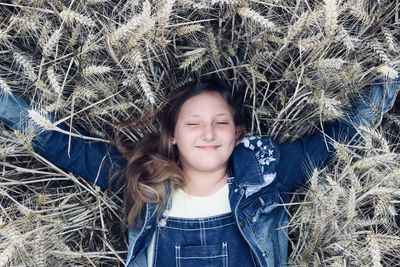 Portrait of smiling girl lying on land