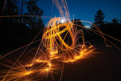 Firework display against sky at night