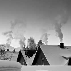 Houses against sky during winter