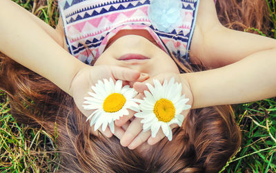 High angle view of woman holding white flowers