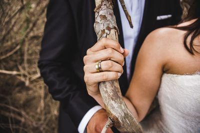 Midsection of couple holding hands