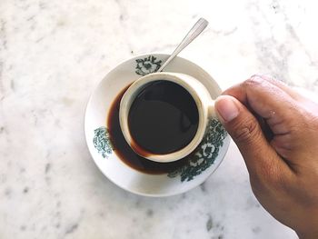 Midsection of person holding coffee cup