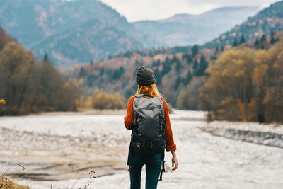 Rear view of man standing on mountain