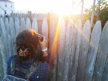View of cow standing on fence