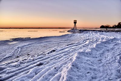 Scenic view of sea against clear sky during sunset