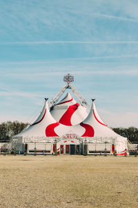 Lifeguard hut on field against sky