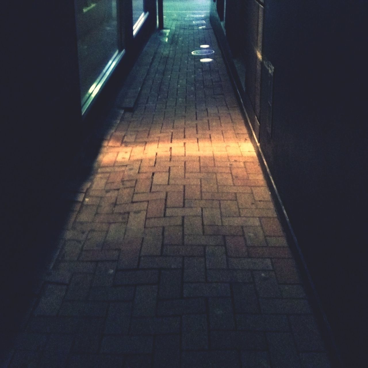 indoors, the way forward, tiled floor, flooring, empty, shadow, sunlight, high angle view, walkway, corridor, diminishing perspective, absence, floor, narrow, paving stone, no people, steps, illuminated, wall - building feature, footpath