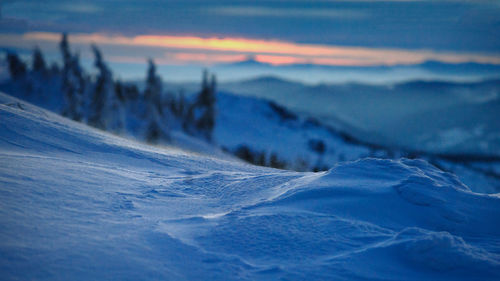 Scenic view of snowcapped mountains against sky during sunset