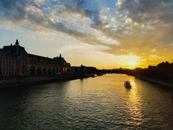 View of river against cloudy sky during sunset