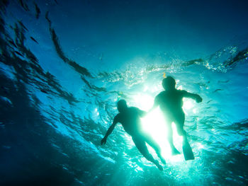 Couple swimming in sea