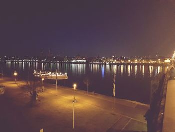 Illuminated city against sky at night