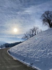 Snow covered field against sky