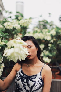 Portrait of woman holding flowers