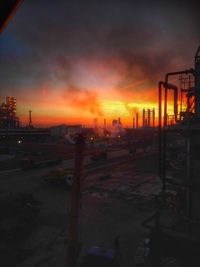 Factory against sky during sunset