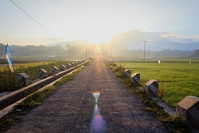 Railroad track against sky during sunset