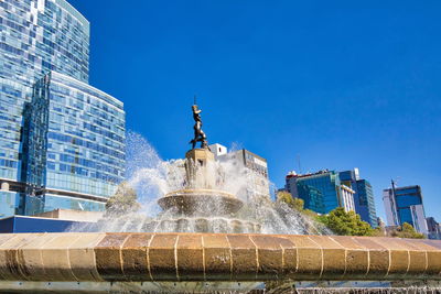 Low angle view of fountain against building