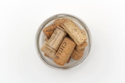 High angle view of cookies in plate against white background