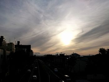 High angle view of street amidst buildings against sky during sunset