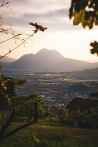 Scenic view of landscape and mountains against sky during sunset