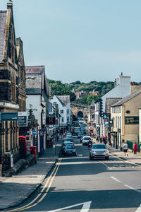 City street by buildings against sky