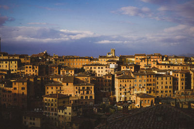 High angle view of buildings in town against sky