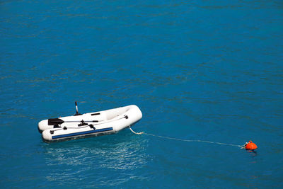 High angle view of boat moored on blue sea