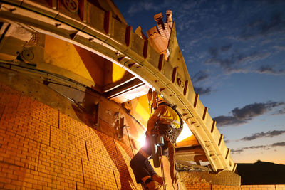 Low angle view of man standing against sky