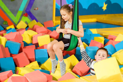 Full length of children sitting in toy