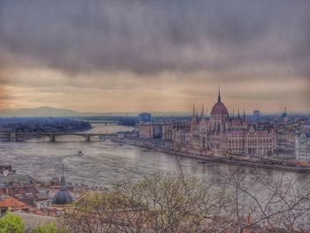 View of cityscape against cloudy sky