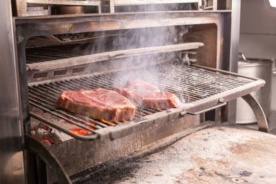 High angle view of meat on barbecue grill