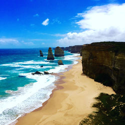 Scenic view of beach against blue sky