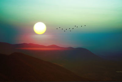 Scenic view of silhouette mountains against sky during sunset