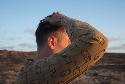 Portrait of young man against sky