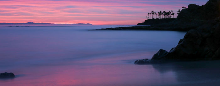 Scenic view of sea against romantic sky at sunset