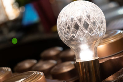 Close-up of light bulb on table