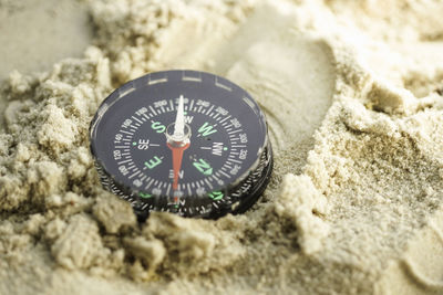 High angle view of clock on sand
