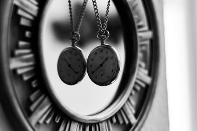 Close-up of pocket watches hanging at home