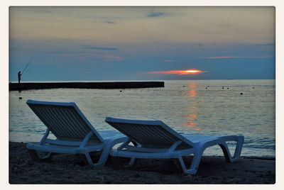 Empty chairs on beach