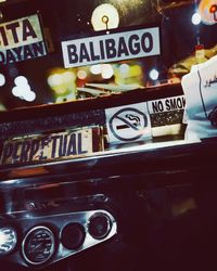 Close-up of illuminated sign on car at night