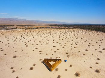 Scenic view of desert against clear blue sky